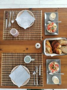 a wooden table with plates of food on it at La Chambre de La Pomerie in Chiché