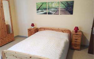 a bedroom with a bed with two night stands and two lamps at Holiday Home Schönberg With Table Tennis 194 in Schoenberg