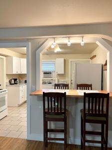 a kitchen with a counter and three chairs in it at Great downtown Sandpoint location! in Sandpoint