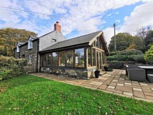 a house with glass windows and a patio at Sea View in Newport