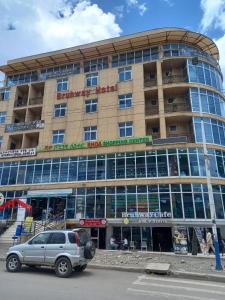 a car parked in front of a building at bruhway hotel in Addis Ababa