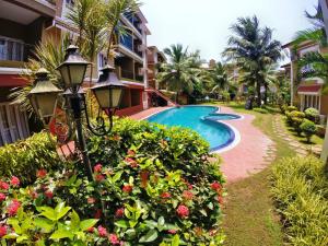 a resort with a swimming pool and a resort at Villa Candolim in Candolim