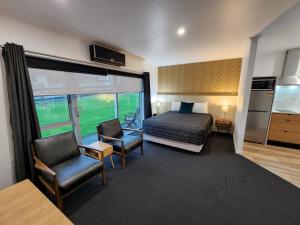 a hotel room with a bed and a window at The Strand in New Plymouth