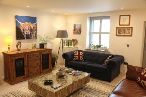 a living room with a couch and a table at 3 Clough Cottages in Clitheroe