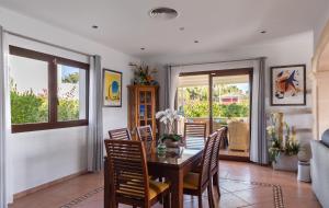 a dining room with a table and chairs at Luxurious villa Sol de Mallorca in Sol de Mallorca