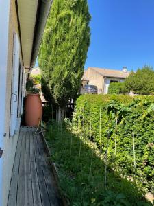 un jardín en un porche con terraza de madera en Maison avec jardin Crest, en Crest