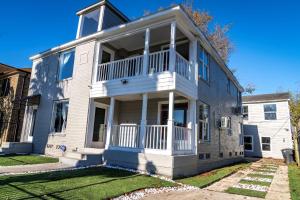 ein großes weißes Haus mit einer großen Veranda in der Unterkunft Private 3Br Gameroom Home In Houston - Sleeps 15 - 2705A in Houston