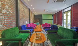 a room with tables and chairs and a brick wall at Treebo Trend The Marwar Hotel & Gardens in Jodhpur