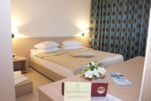 Postel nebo postele na pokoji v ubytování Hotel Sara