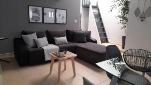 a living room with a couch and a table at Apt22 stylish apartment close of Heraklion center in Heraklio Town