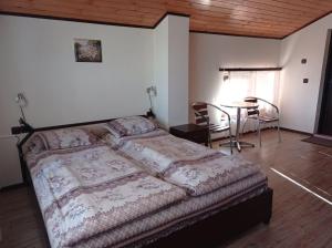 a bedroom with a bed and a table and chairs at Villa Prolet in General-Kantardzhievo