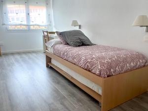 A bed or beds in a room at Apartamento Larrabide