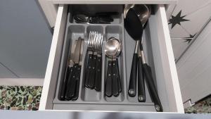 a drawer filled with utensils in a cabinet at ANNAS HOUSE in Psakoudia