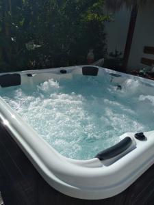 a jacuzzi tub with water in it at Home Beach Dream House in Carvalhal
