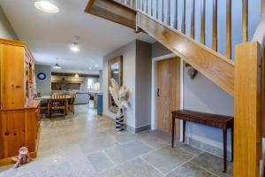 a living room with a staircase and a dining room at The Hay Barn in Doncaster