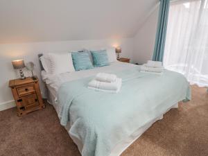 a bedroom with a large bed with towels on it at Yeavering in Wooler