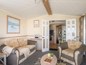 uma sala de estar com dois sofás e uma mesa em Trewan Lodge em Holyhead