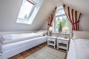 ハリスレーにあるfewo1846 - Palstek - elegante Maisonettewohnung auf parkähnlichem Grundstückのベッドが2つと窓が2つある寝室