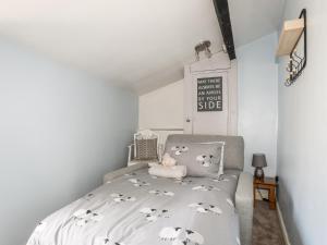 a bedroom with a bed with sheep sheets at Dolwar in Amlwch
