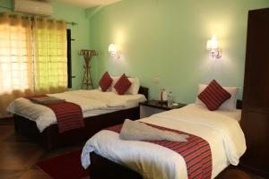 A bed or beds in a room at Wild Adventure Resort