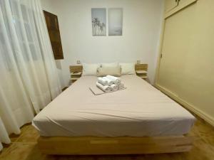a bedroom with a white bed with towels on it at Tu Casa in Puerto de Mazarrón +22 photos