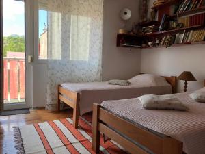 a small room with two beds and a window at Apartment TARGET in Cetinje +16 photos