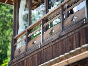 a group of birds perched on the side of a bridge at Yunoshimakan in Gero