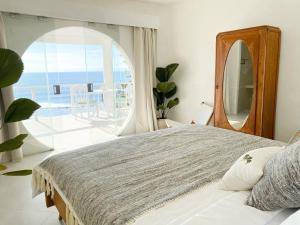a bedroom with a bed and a view of the ocean at Blue Ocean Bingin in Uluwatu