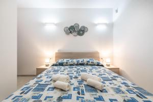 a bedroom with a large bed with two pillows at Casa vacanza Porto Luna Villasimius in Villasimius