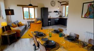 a living room with a dining table and a kitchen at Walnut Lodge Espas 2 bedroom, Barn Conversion in Espas