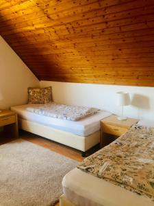 a bedroom with a bed and a wooden ceiling at Summerside Apartman Harkány in Harkány