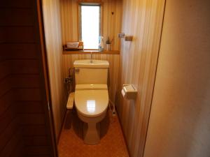 a bathroom with a toilet with a window in it at Guest House Inujima / Vacation STAY 3516 in Toyama