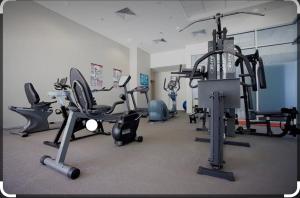 a gym with several exercise equipment in a room at Seaside Stays Marcoola Private studio 2515 in Marcoola
