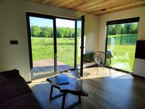 a living room with a couch and a table at Czarny Domek Mazury in Pozezdrze