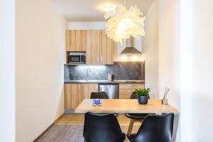 a kitchen and dining room with a table and chairs at Pilsner Apartments in Pilsen