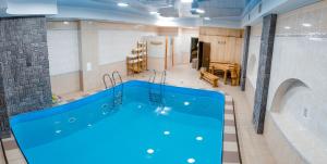 a large blue bath tub in a room at Medeu in Kostanay
