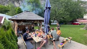 a group of people sitting at tables under an umbrella at Fankhauser OutdoorSport in Haiming