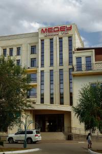 a msg building with a car parked in front of it at Medeu in Kostanay