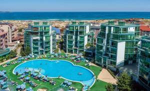 an aerial view of an apartment complex with a pool and the ocean at Spacious and cozy Apartment in complex Del Sol in Primorsko