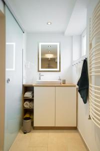 a bathroom with a sink and a mirror at Ferienwohnung Am Kahlenberg - Ringsheim in Ringsheim