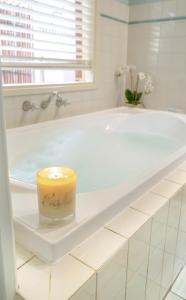 a candle sitting on top of a bath tub at Adelaide Style Accommodation - City to Beach - Free WIFI - Free 3 car parking - Great location in Adelaide