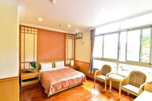 Katil atau katil-katil dalam bilik di Jenq Yang Hotspring Hotel