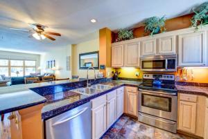 a kitchen with white cabinets and blue counter tops at 100-2 Lakeside Village in Keystone