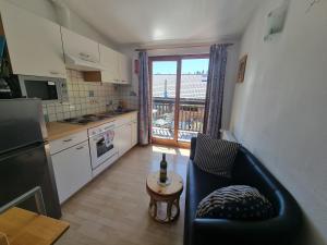 a kitchen with a couch and a table in a room at Ferienhaus Waldhof in Hermagor