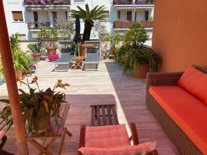 a balcony with a couch and chairs on a building at Calma di vento in Sestri Levante