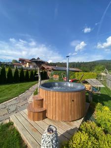 a hot tub in the middle of a yard at Agritur Bella di Bosco in Coredo