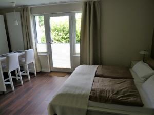 a bedroom with a bed and a large window at Apartment Ankenbrand in Randersacker
