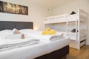 two beds in a room with a bunk bed at Ferienwohnung Am Kahlenberg - Ringsheim in Ringsheim