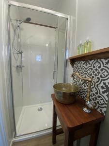 a bathroom with a sink and a shower at Heywood Glamping in Ormskirk