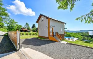a small white house with a fence and a pool at Nice Home In Varazdinske Toplice in Varaždinske Toplice